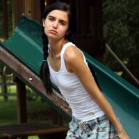 Petite slim girl naked in the playground