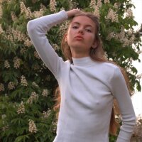 Young and small Alena undressing outdoors