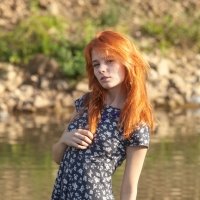 Little red haired girl nude along the river